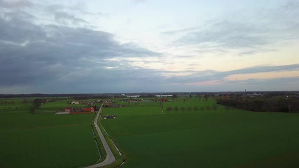 Flying Over Green Meadow with Small Trees