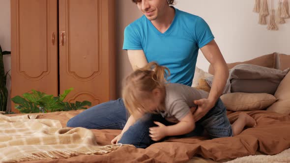 Dad and Daughter Play in Bedroom Happy Family on Bed