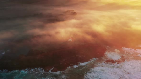 Drone Soaring Above Beautiful Ocean Waves at Magical Golden Orange Sunrise