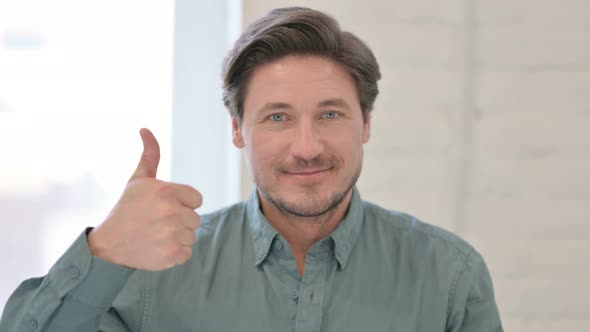 Portrait of Middle Aged Man showing Thumbs Up Sign 