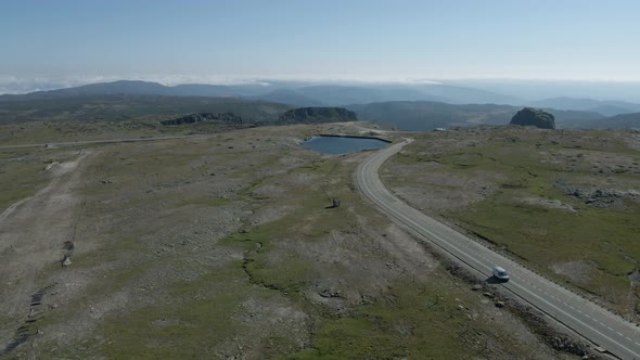 Isolated car driving on road at Serra da Estrela, Portugal. Aerial panoramic view