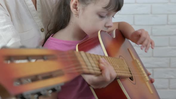 Child play on guitar. 