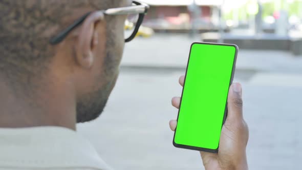 Close Up of African Man Using Green Screen Smartphone Outdoor