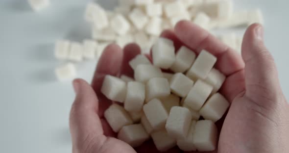 Men's Hands Put Sugar Cubes on the Table
