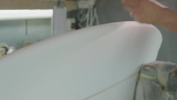 Male surfboard maker in his workshop