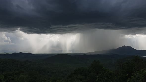 Rain storms and black clouds moving over the mountains.