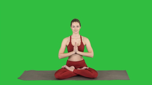 Beautiful young woman sitting in yoga pose Lotus