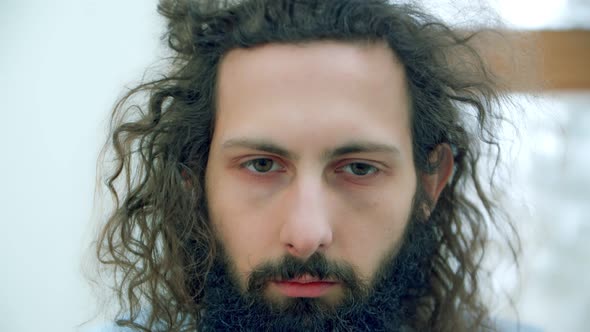 Closeup Curly Man Drinks Coffee and Instantly Awakens