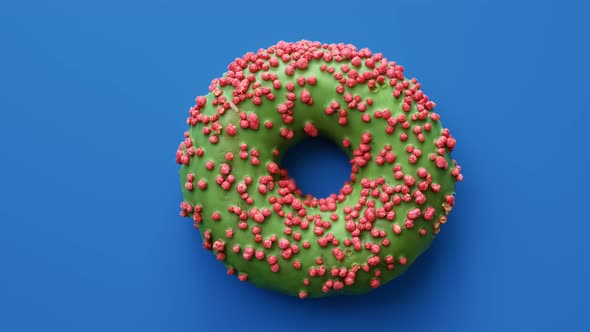 Tasty Doughnut Covered By Green Glaze and Pink Sprinkle Rotate Isolated