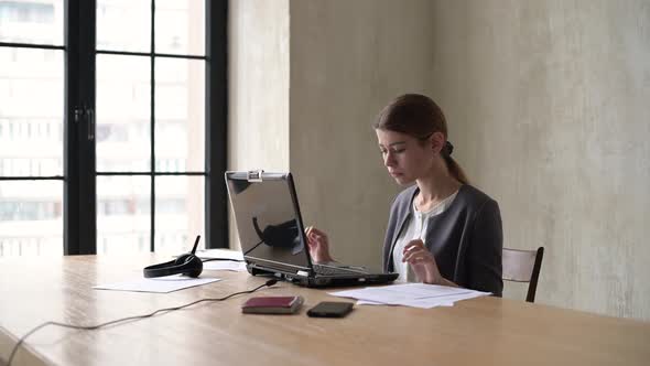 A young office worker freaks out, loses her temper and scatters documents