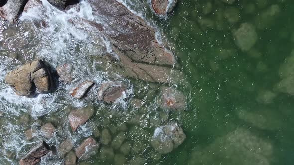 Water Rinses Rocks of Hong Kong UNESCO Global Geopark in Shek O, Aerial Top Down