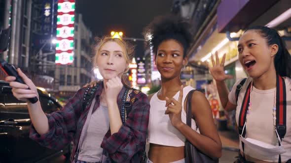 multi-ethnic female friends are enjoying a night out on Yaowarat Road or Chinatown in Bangkok