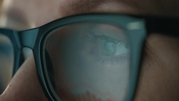 Woman in Glasses Looking on the Monitor and and Working with Charts and Analytics