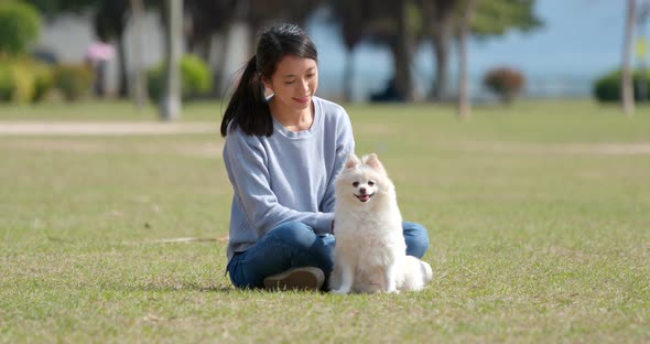 Young Woman training with her dog at outdoor park