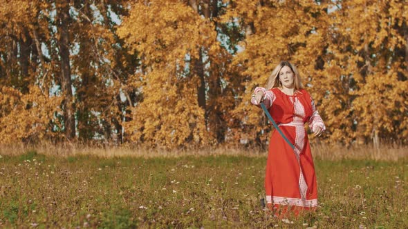 Medieval Concept - Woman in Red National Europe Long Dress Rotating a Sword Around Herself