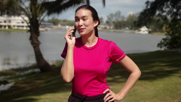 Happy Sportive Woman Talking on Phone