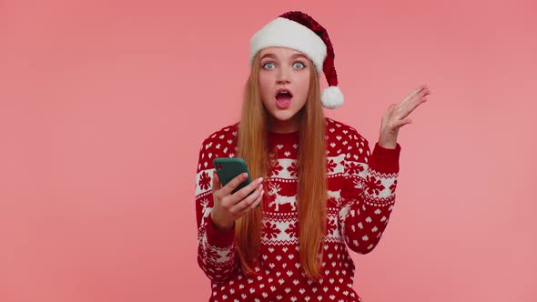 Adult Girl in Christmas Sweater Looking Smartphone Display Sincerely Rejoicing Win Success Luck