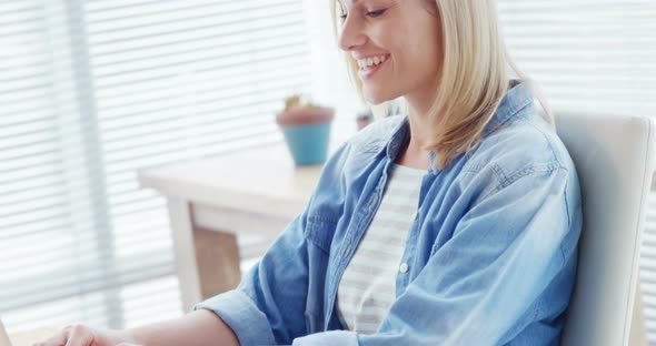 Businesswoman working over laptop at her desk