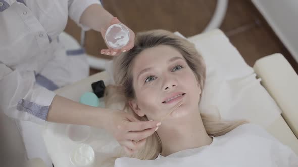 Closeup Top Portrait of Charming Young Blond Woman Having Professional Skin Care Procedures in