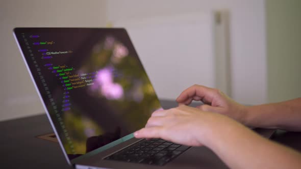 A Programmer is Writing Program Code on the Laptop