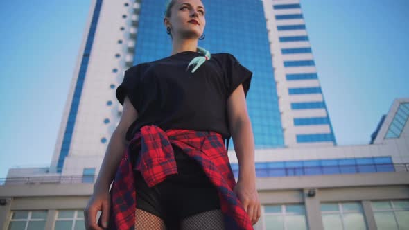 Portrait of Young Stylish Funky Hipster Woman with Green Hair on Urban Buildings Backgorund Slow