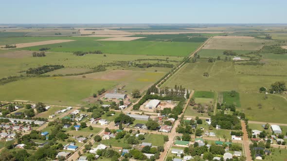 Aerial view parallax of little town of Santa Anita with Entre Rios green countryside in background,