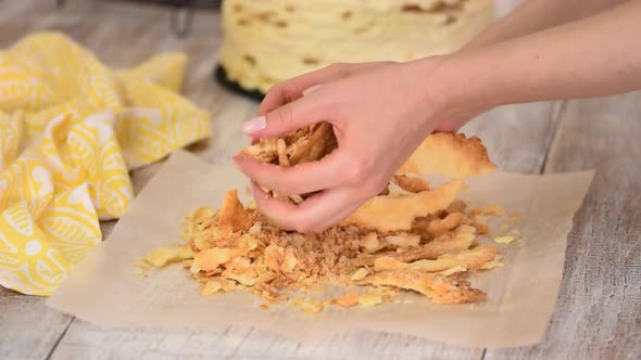 Woman hands making crumble for napoleon cake.	