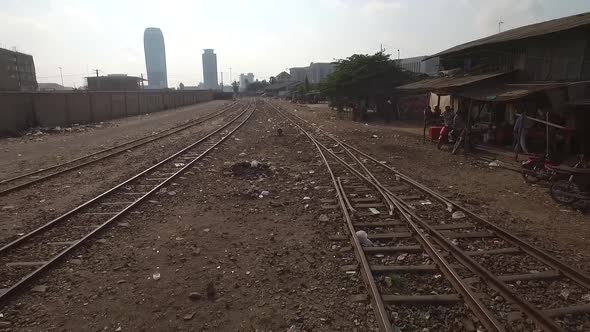 Aerial view of train track crossing poor neighborhood, Phnom Penh, Cambodia.