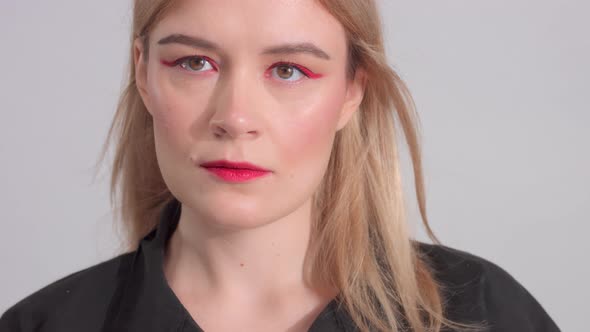 Blonde Woman with Bright Red Makeup in Studio