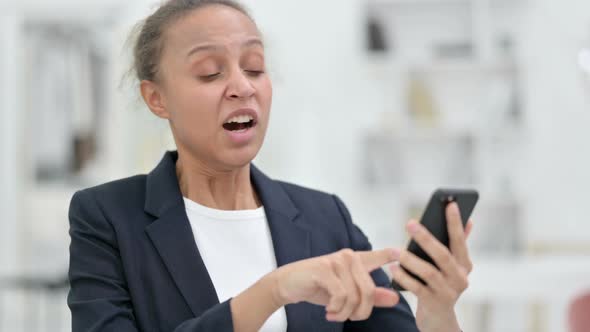 Portrait of African Businesswoman Having Loss on Smartphone 