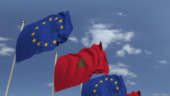 Waving Flags of Morocco and the EU on Sky Background alt