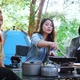 Group of young women cooking while camping in park - VideoHive Item for Sale
