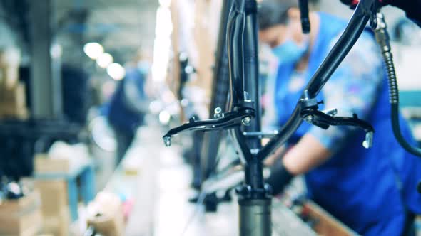 Factory Worker Is Processing a Bicycle Body Frame