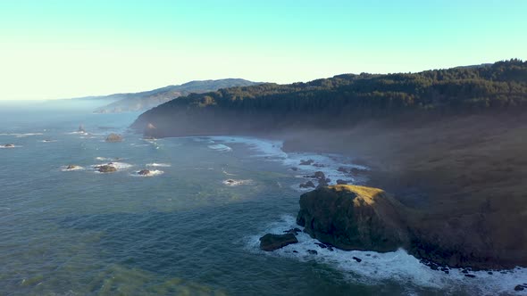 Cape Ferrelo at the wild Oregon Coast, aerial. Misty hazy atmosphere.