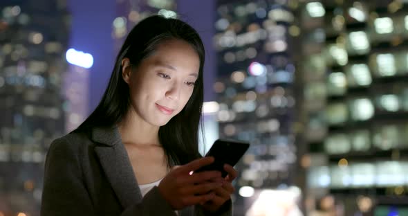 Business woman use of cellphone at night