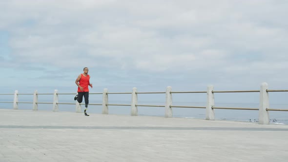 Side view man with prosthetic leg running