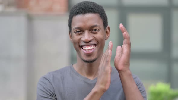 Portrait of Appreciative Young Young African Man Clapping 