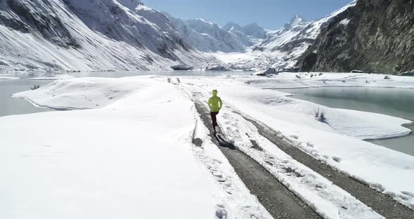 Woman trail runner cross country running in winter nature,Aerial view drone footage 