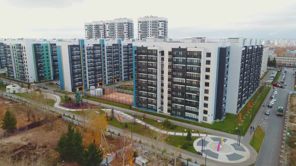 Curvy Road in Park Near Large Apartment Buildings in City