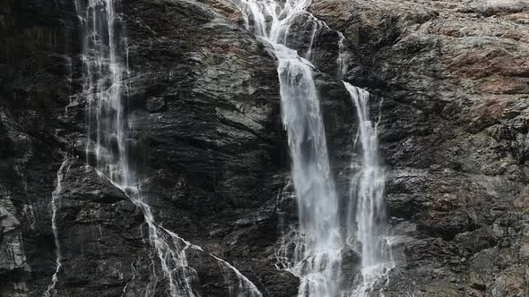 Waterfall On The Swiss Alps Descends From The Glaciers