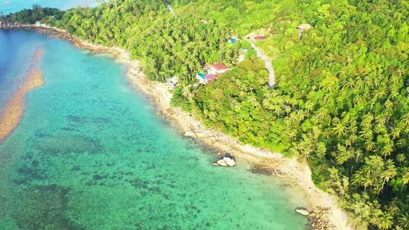 Aerial top down nature of tropical tourist beach wildlife by shallow lagoon and white sandy backgrou