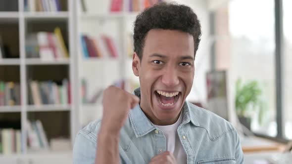 Excited Young African American Man Celebrating Success Winning
