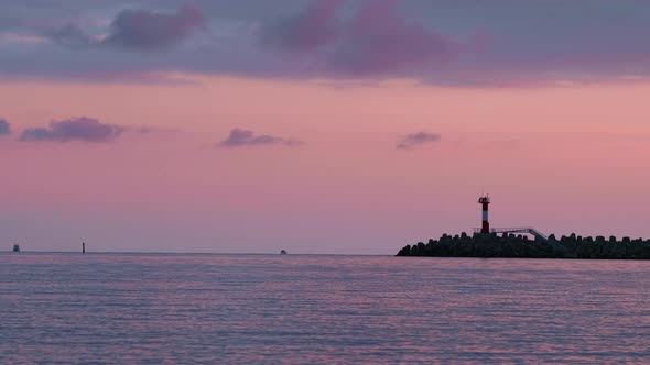 Silhouette of Lighthouse on Colorful Sunset Background