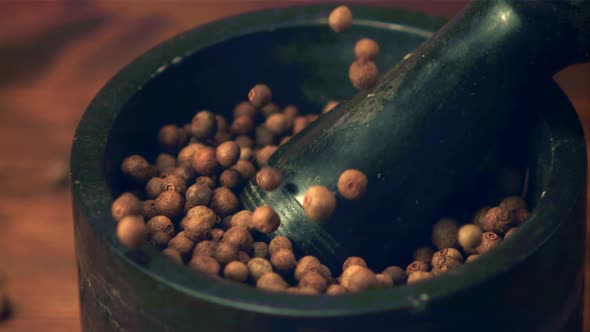 Super Slow Motion in a Mortar with a Pestle Fall Peas of Black Pepper