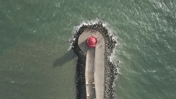 Top View Of People Walking Around The Poolbeg Lighthouse At The Mouth Of River Liffey Near Poolbeg,