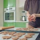 Young Woman in Brown Tshirt Backing Cookies on a Silicon Mat at Home Kitchen - VideoHive Item for Sale