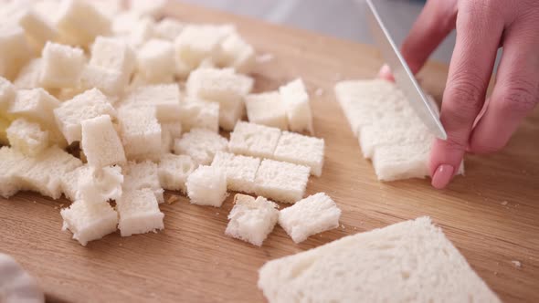 Making Caesar Salad Croutons By Slicing Toast Bread