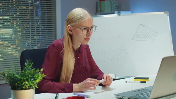 Woman Teacher Explaining Information to Somebody By Video Call Using Whiteboard