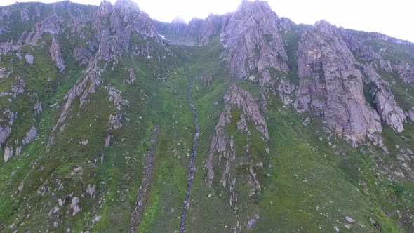 Rocky Walls Rising From Alpine Meadows