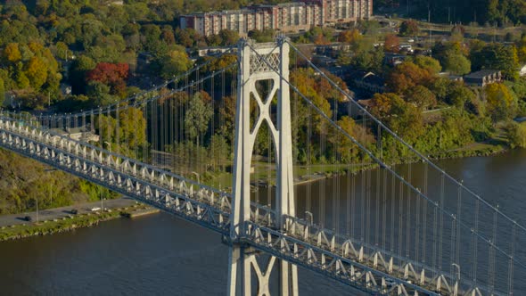 Aerial of Mid-Hudson Bridge and town amidst autumn trees at distance